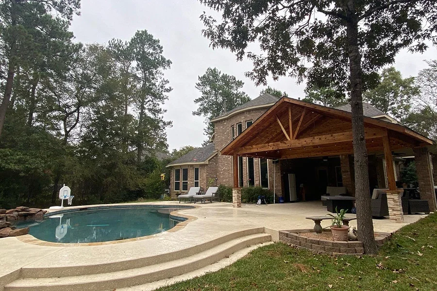 happy Houston family enjoying backyard BBQ next to a sparkling modernized pool - old pool renovation