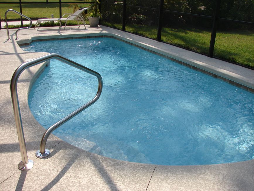 Pool replastering Houston backyard concrete pool smooth surface close-up - Pool replastering Houston
